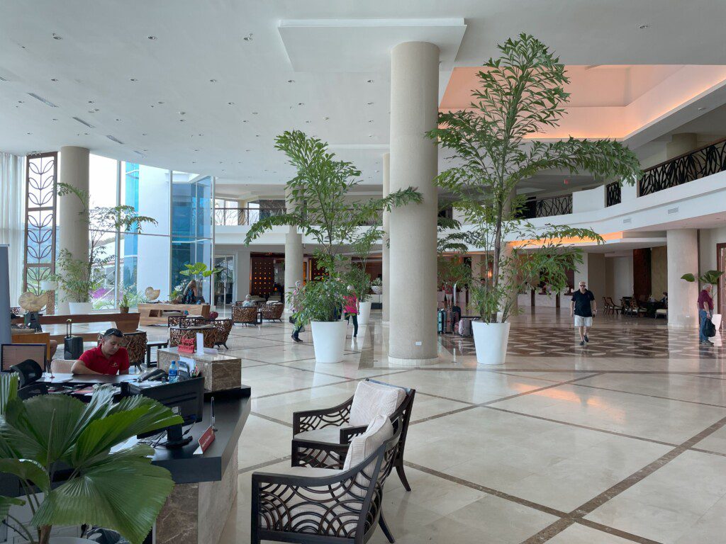 a large lobby with trees and people