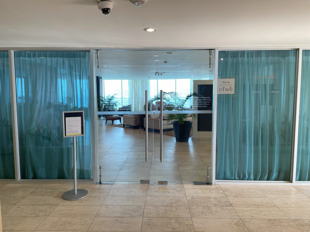a glass doors with blue curtains