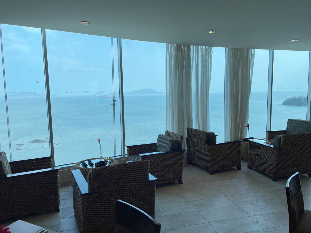 a room with chairs and a view of the ocean