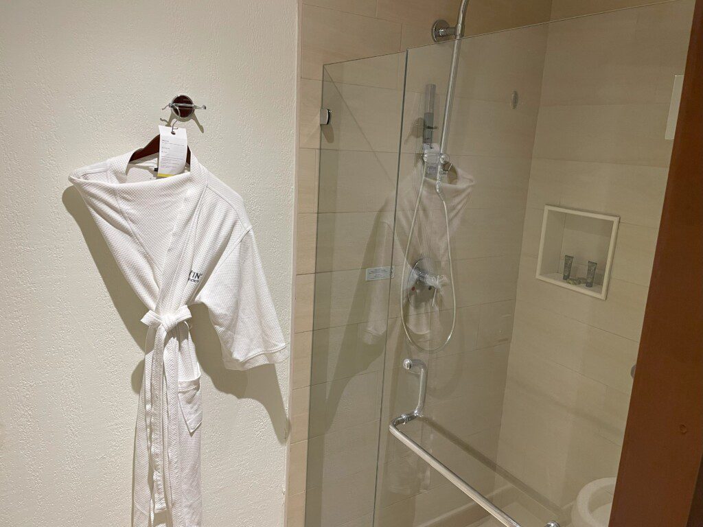 a white robe on a swinger in a bathroom