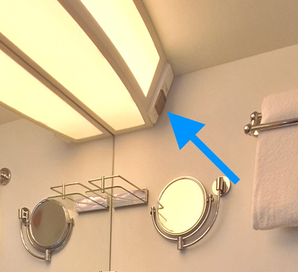 a bathroom with a light fixture and a mirror